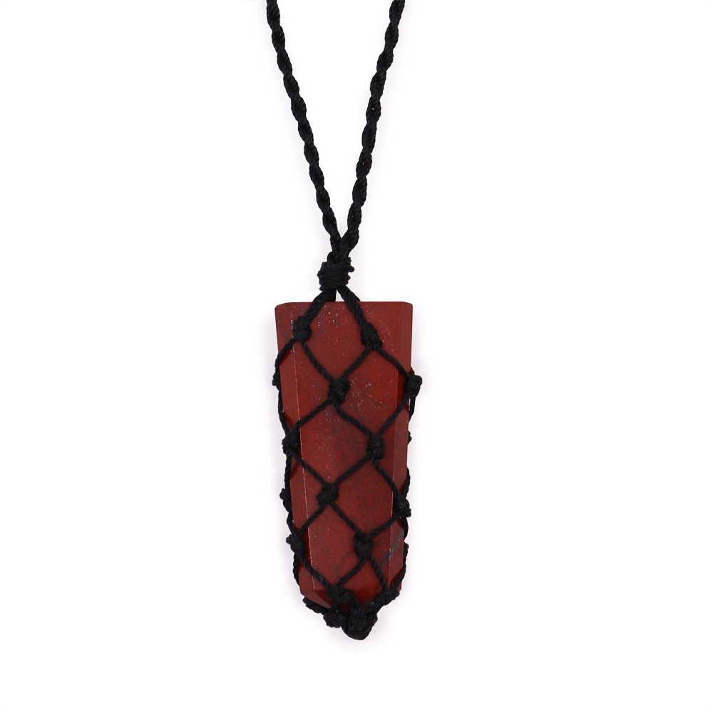 A red, rectangular gemstone hangs from a black, braided cord. The stone is encased in a knotted, black net. The backdrop is a bright, plain white.