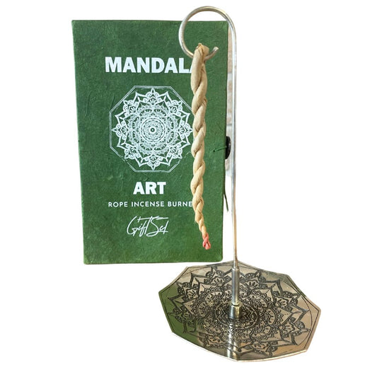 A twisted rope incense hangs from a metallic holder with a decorative mandala base. Behind it, a green packaging reads "MANDALA ART ROPE INCENSE BURNER Gift Set" with a mandala design.