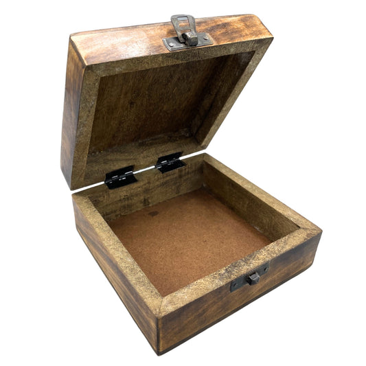 A wooden box with a hinged lid is open, revealing an empty interior. The box is secured with small metal clasps and rests on a plain, white background.