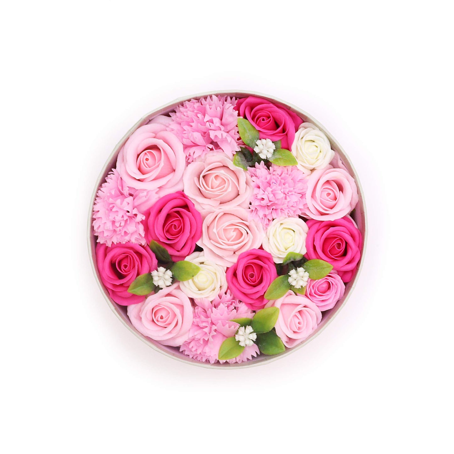 A circular arrangement of pink and white roses and carnations sits in a light gray round box, against a white background.