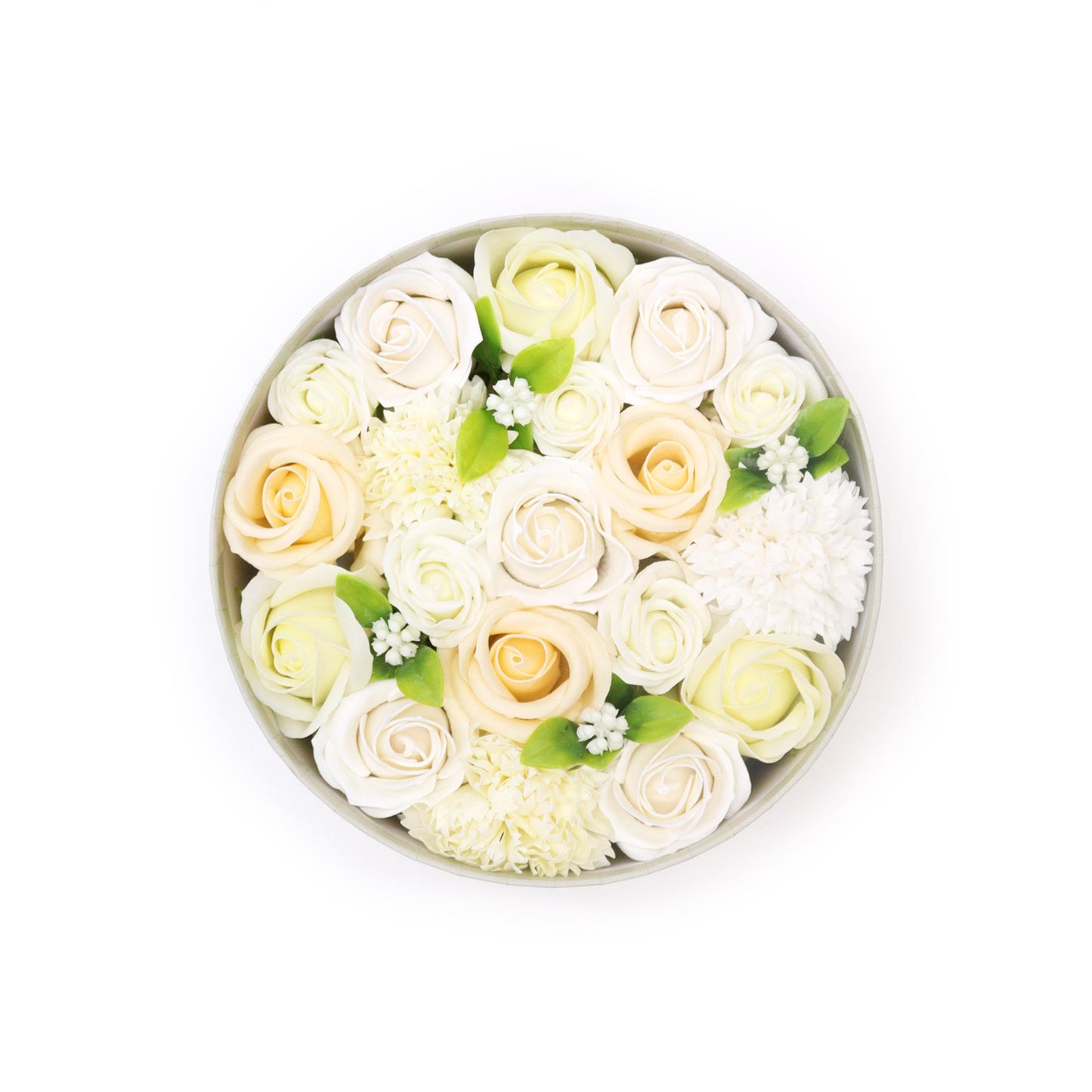 Roses and smaller white flowers are arranged in a round box. The roses are off-white and pale yellow. The box sits on a white background.