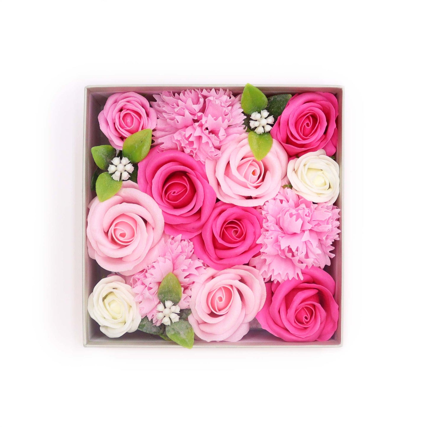 Pink and white soap roses and carnations are arranged in a square box against a white background.