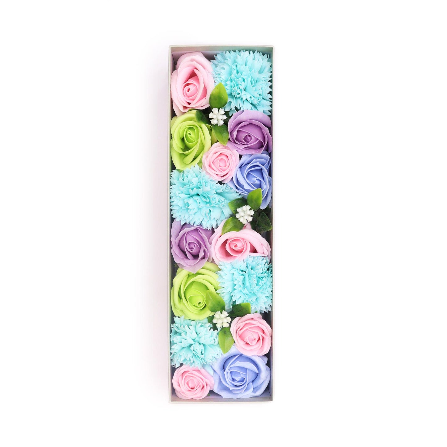 Pastel-colored soap flowers are arranged in a rectangular box to form the letter “I”. The box sits on a white background.