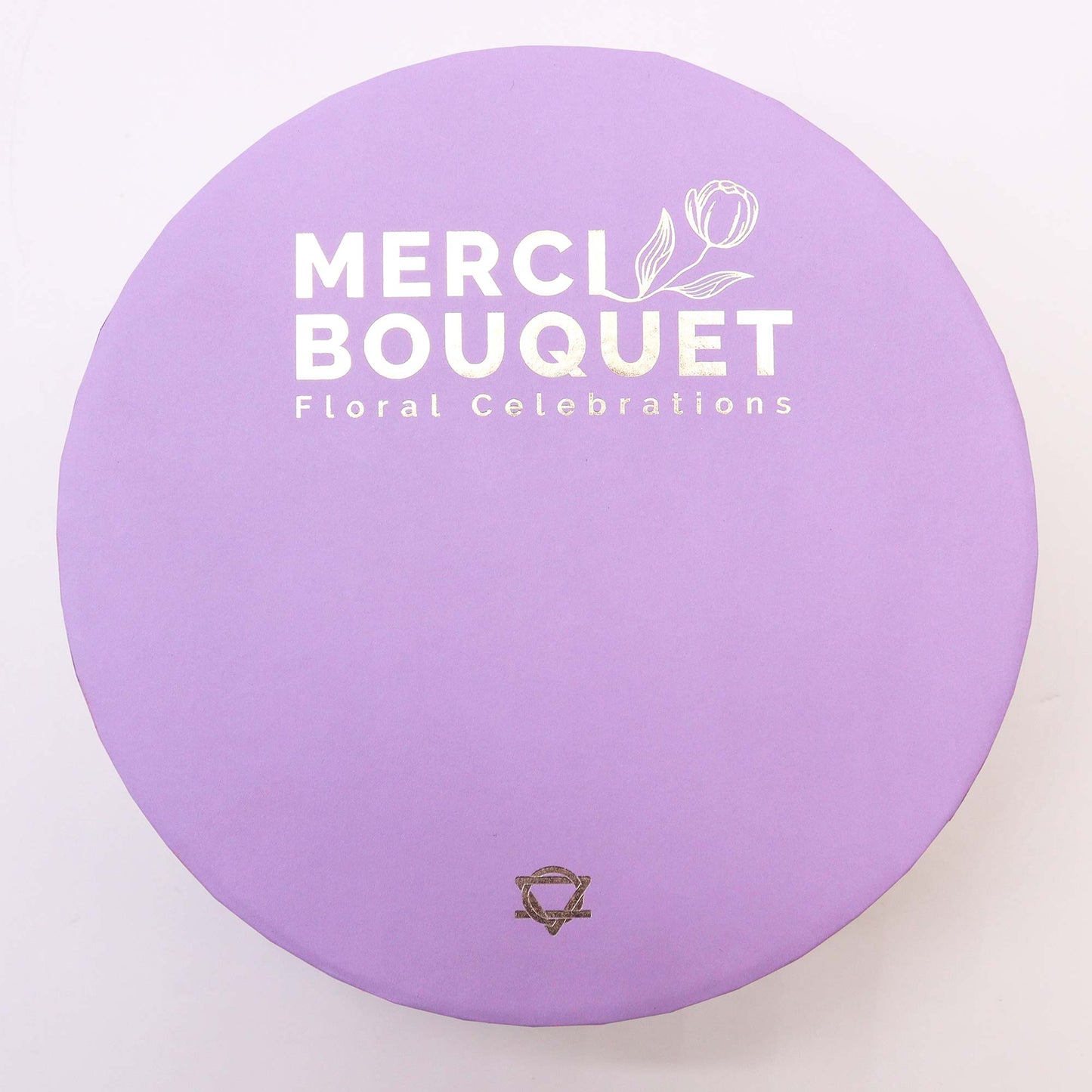 A round, light purple box displays "MERCI BOUQUET Floral Celebrations" and a small logo.