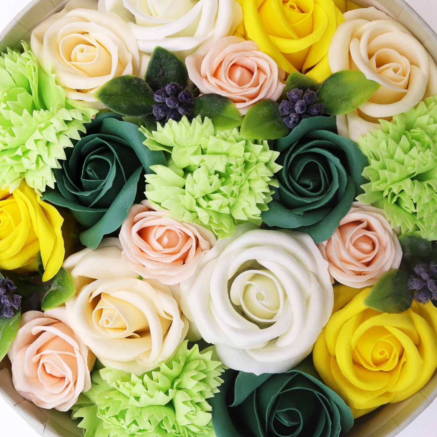 Soap roses and carnations of various colors are arranged in a circular box. The roses and carnations are densely packed together, creating a full and lush bouquet.