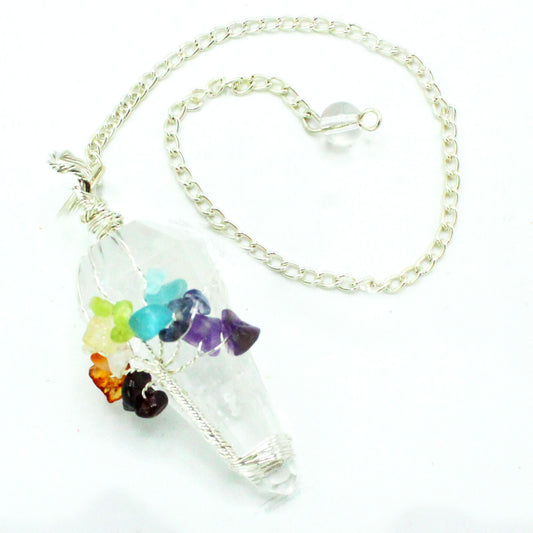 A quartz crystal pendulum with a silver chain is presented, wrapped with wire and adorned with colorful chakra stones on a white surface.