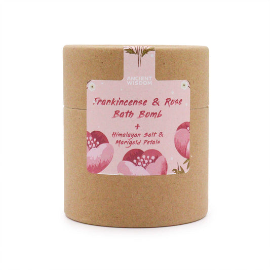 A cylindrical cardboard container labeled "Frankincense & Rose Bath Bomb + Himalayan Salt & Marigold Petals" is displayed. The label features floral illustrations, set against a plain white backdrop.