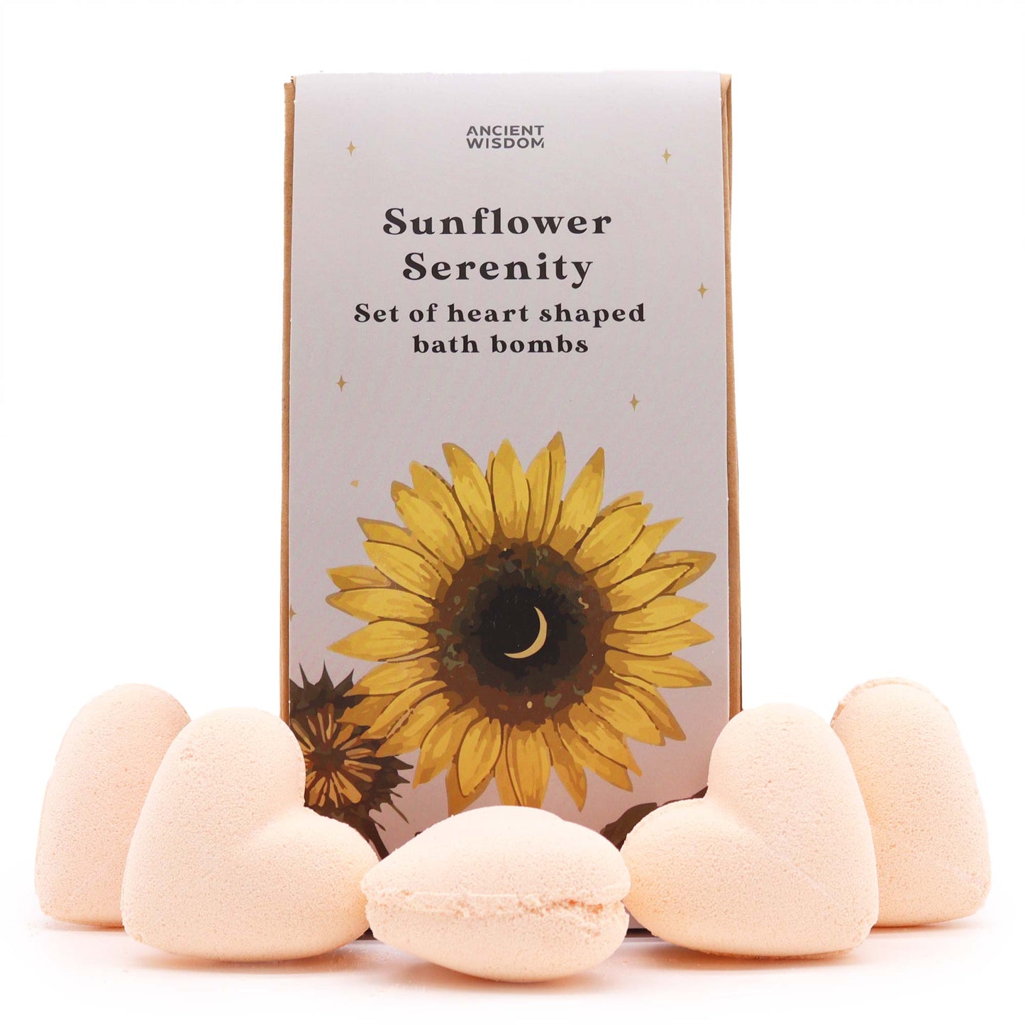 Five peach-colored, heart-shaped bath bombs rest in front of a box labeled "Ancient Wisdom Sunflower Serenity Set of heart shaped bath bombs," featuring a sunflower with a crescent moon center.