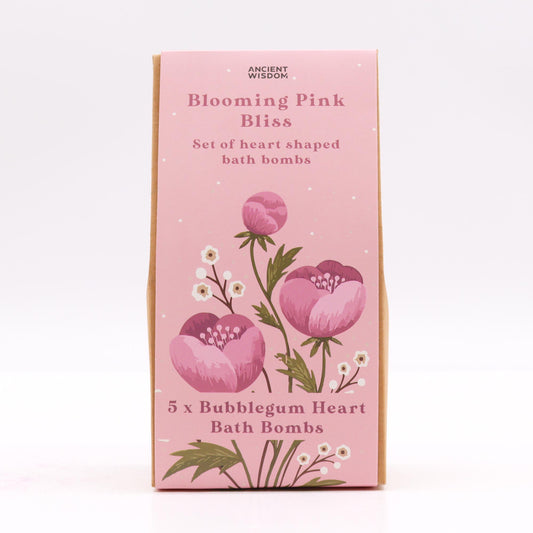 The package features a pink floral design and text: "ANCIENT WISDOM, Blooming Pink Bliss, Set of heart shaped bath bombs, 5 x Bubblegum Heart Bath Bombs," against a plain backdrop.
