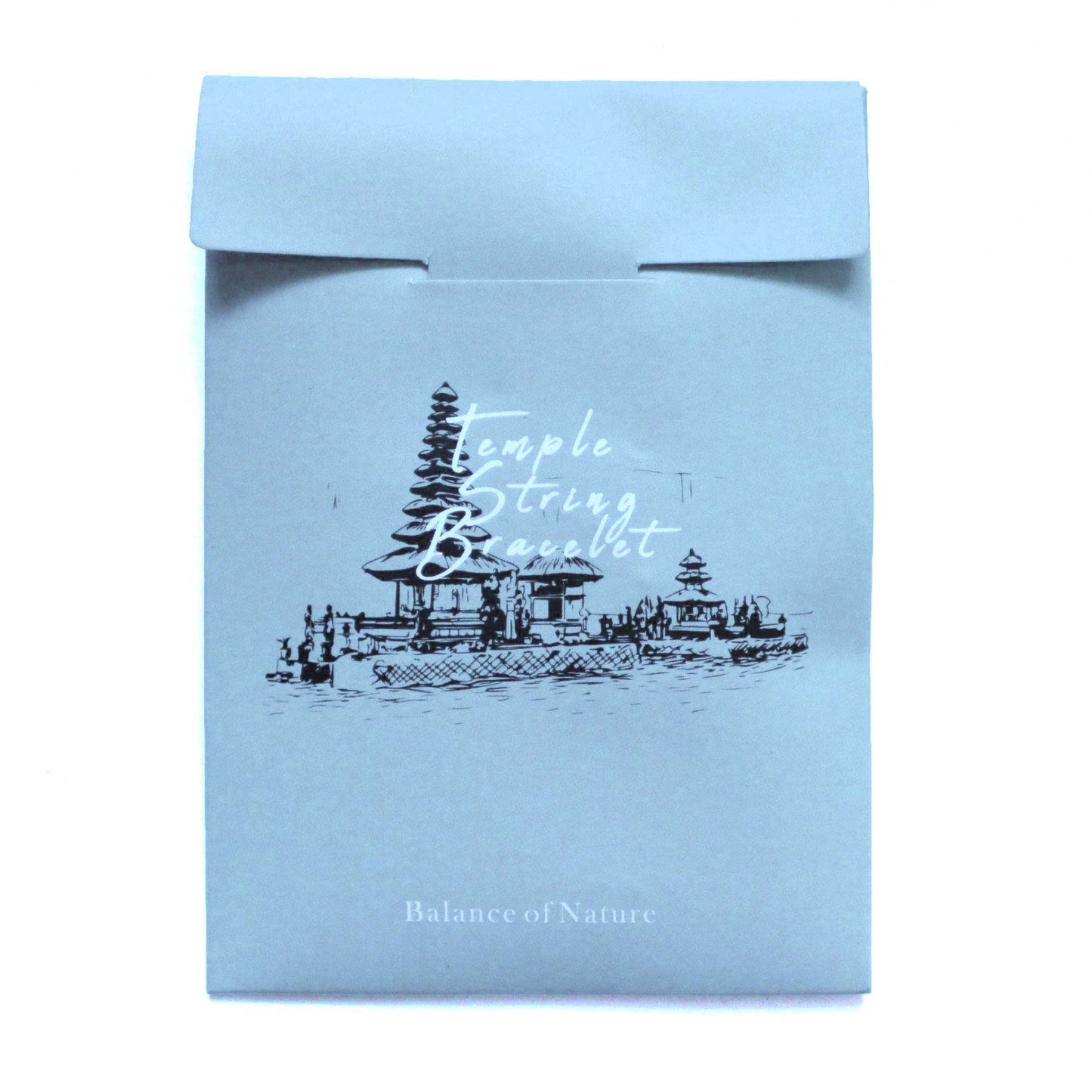 A light blue, folded paper envelope displays a black sketch of a temple complex on water with the text "Temple String Bracelet" above and "Balance of Nature" below.