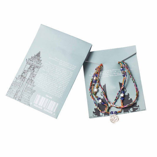 A multi-strand, beaded bracelet hangs on a pale blue product card that has text on it: "Wear this bracelet to find mindfulness and serenity in each and every moment... TSJ-04 5 056368 334023 >".