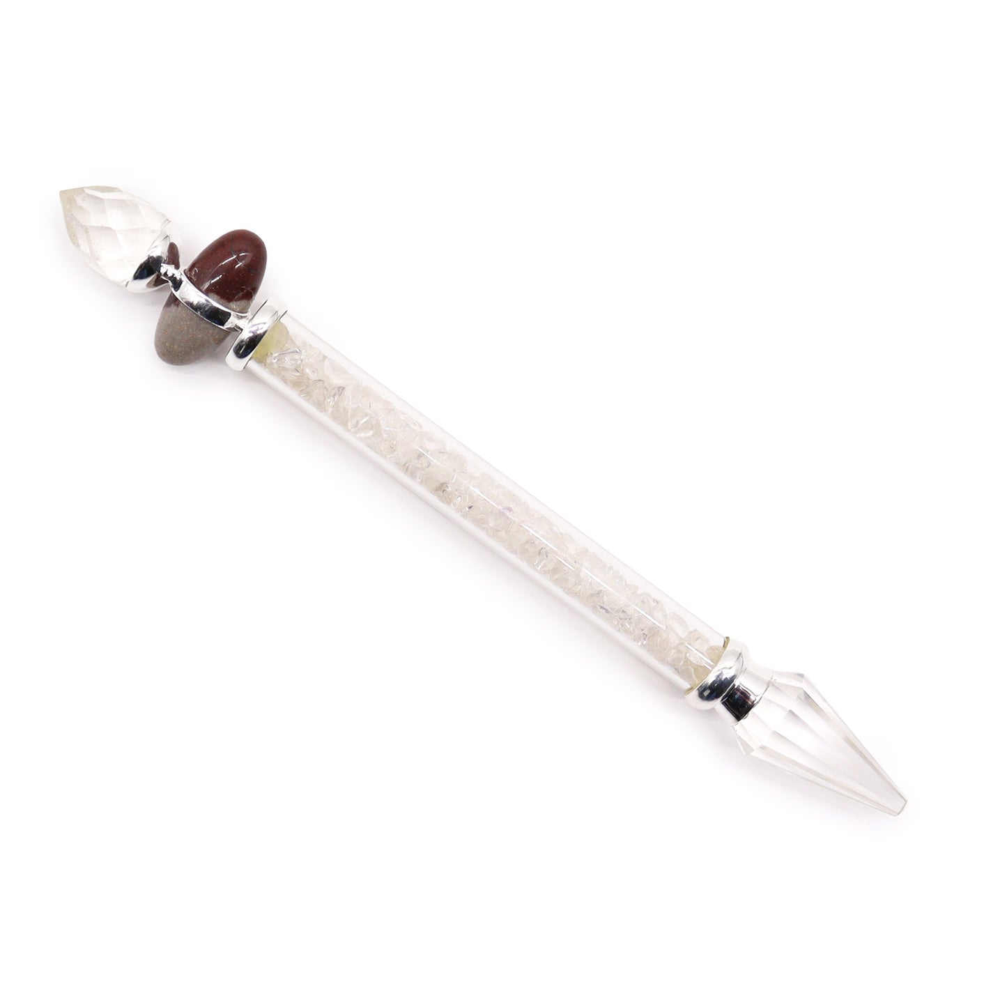 A crystal wand lays diagonally on a white background. It's made of a clear tube filled with small, clear crystals and capped with larger crystals and stones.