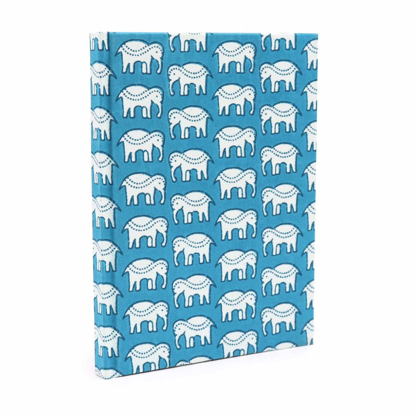 A book is standing upright, covered in blue fabric featuring a repeated pattern of white elephants with decorative dots. The background setting is simple and white, emphasizing the book's design.