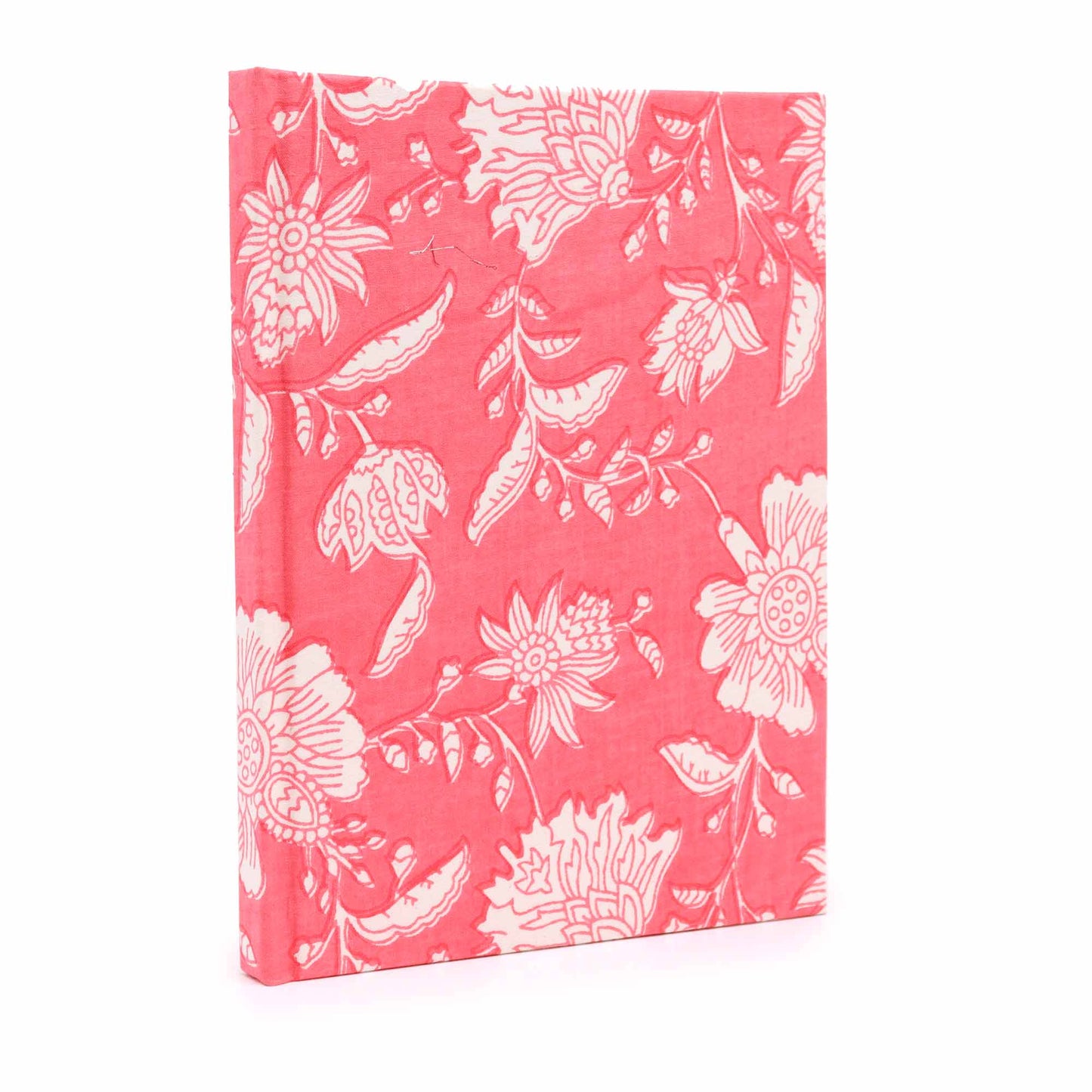 A hardcover book stands upright, decorated with a vibrant pink floral pattern. The intricate white flowers and leaves cover its surface, set against a plain, white background.