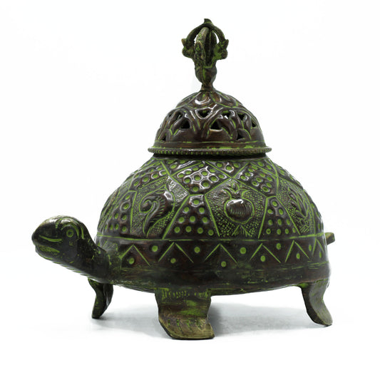 A bronze-green turtle-shaped incense holder with intricate patterns on its shell and a decorative, detachable lid. It rests on four legs, in a plain white background.