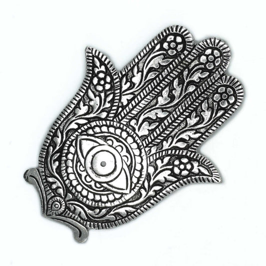 Ornate silver hand-shaped amulet, the Hamsa, features intricate floral and vine patterns with a central eye symbol. It lies flat, filling most of the plain, white background.