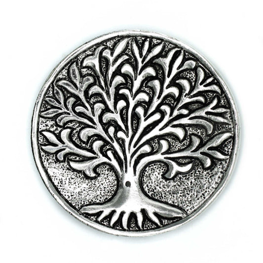 A round metallic medallion features a raised tree with intricate, swirling branches. The textured background enhances its detailed design, creating a sense of depth against the smooth surface.