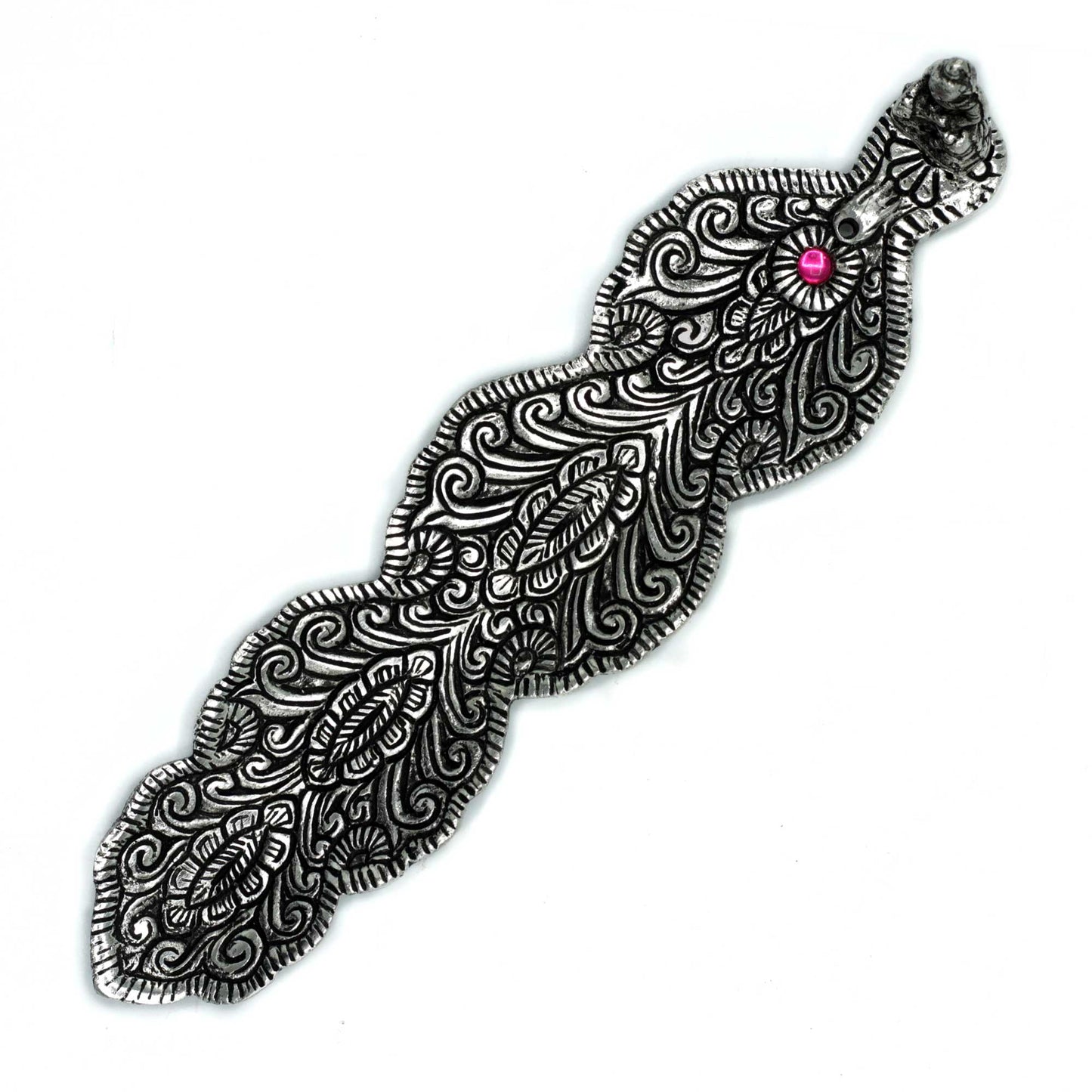 An intricately designed silver metal object resembling a feather, featuring swirling patterns and a central pink gem. The object is set against a plain white background.