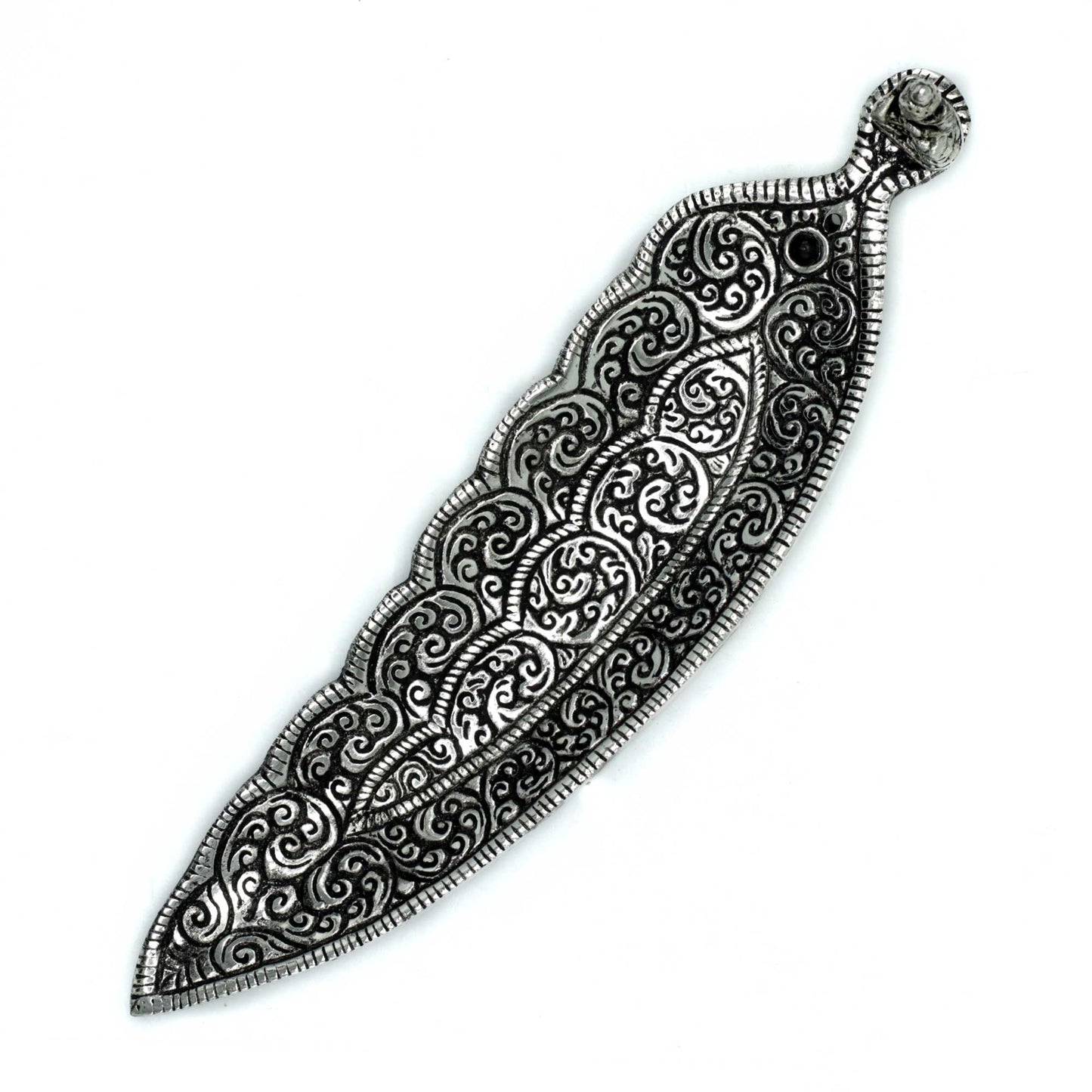 An intricately designed, ornamental metal leaf features swirling patterns and curved edges, set against a plain white background.