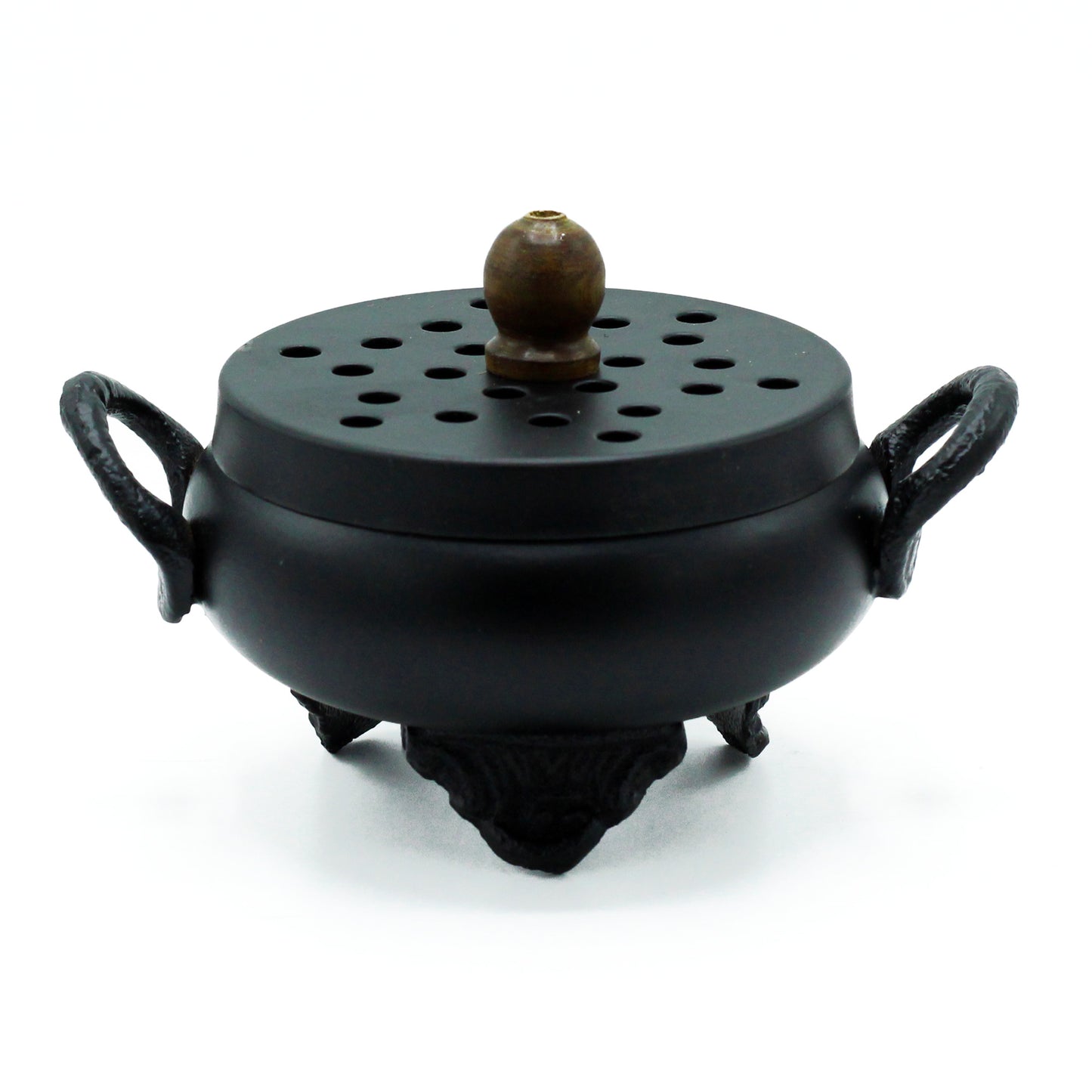A black, round incense burner with two handles and a perforated lid sits on three ornate legs, placed on a plain white background.
