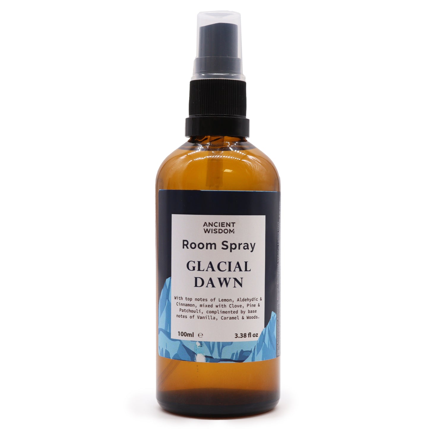 A brown glass bottle, containing room spray, sits on a white background. The spray bottle is labeled “Room Spray Glacial Dawn,” and lists its fragrance notes.