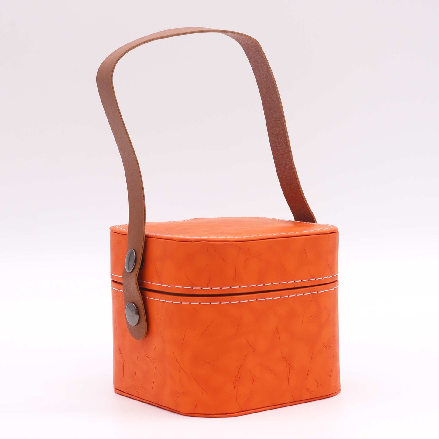 A small orange box with a brown leather handle sits on a white background.