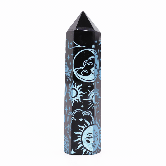 A black, faceted crystal tower displays intricate azure celestial designs of suns, moons, and stars, set against a plain white background.
