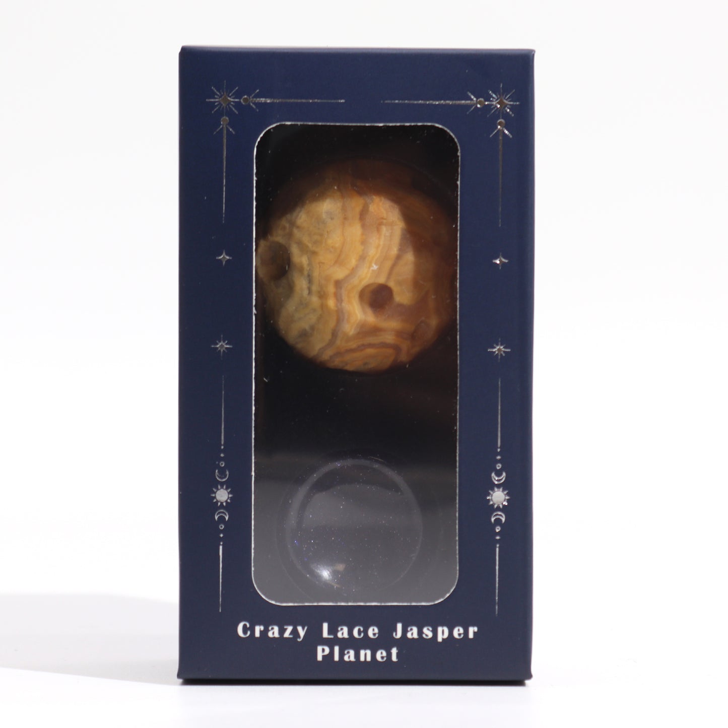 A Crazy Lace Jasper Planet is displayed in a navy blue box with celestial-themed decorations. Below it is a smaller, dark purple orb. The box reads: “Crazy Lace Jasper Planet”.