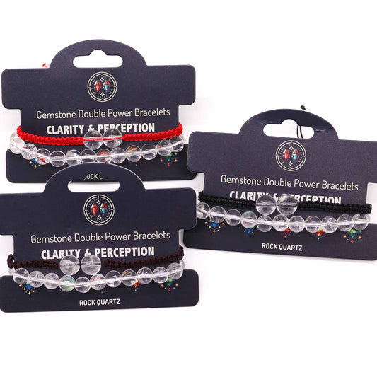 Three gemstone bracelets, displayed on cards, feature clear beads and colored cords; the cards advertise "Gemstone Double Power Bracelets CLARITY & PERCEPTION" and specify "ROCK QUARTZ".
