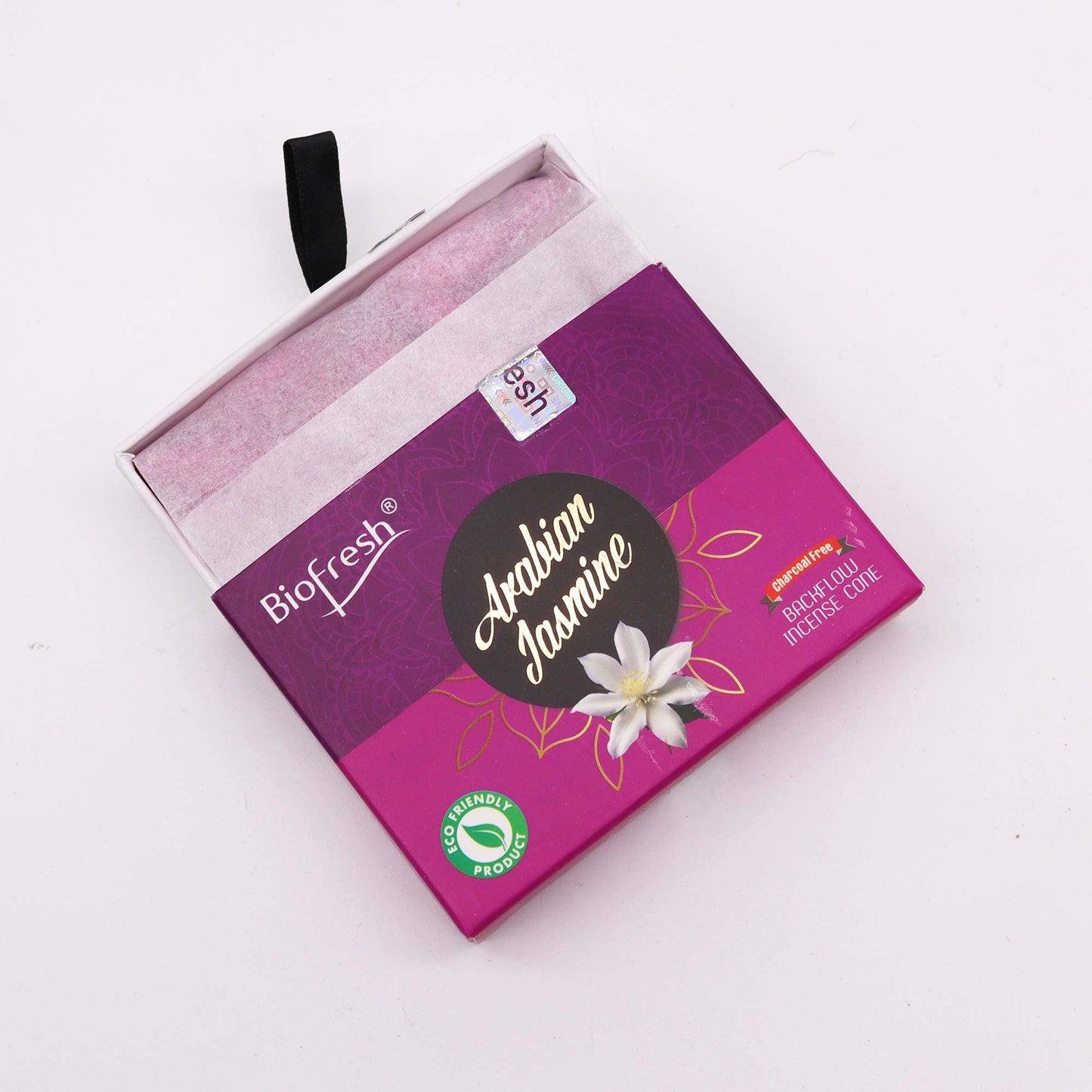 A purple box containing incense cones sits slightly open on a white surface. The box displays “Biofresh,” “Arabian Jasmine,” “Charcoal Free,” “Backflow Incense Cone,” and “Eco Friendly Product.”