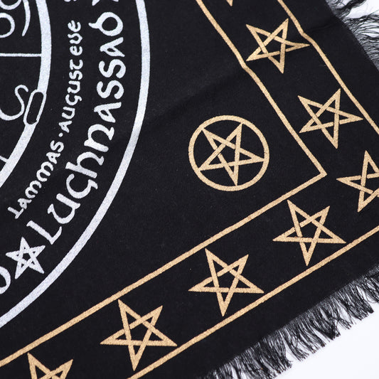 A black cloth displays gold pentagrams and a circular design including the words "Lammas, August eve, Lughnasadh" on a white background.