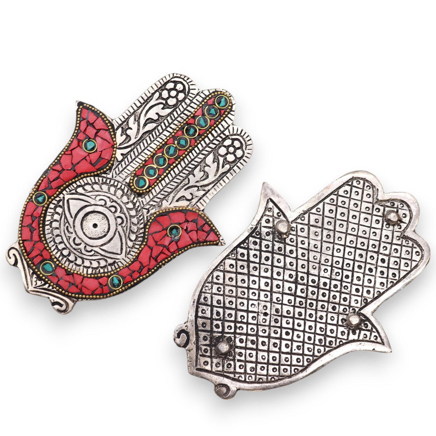 Two ornate metal Hamsa hand pendants are shown. One features red and turquoise detailing with intricate patterns, while the other has a textured, grid-like backside. They are displayed on a white background.