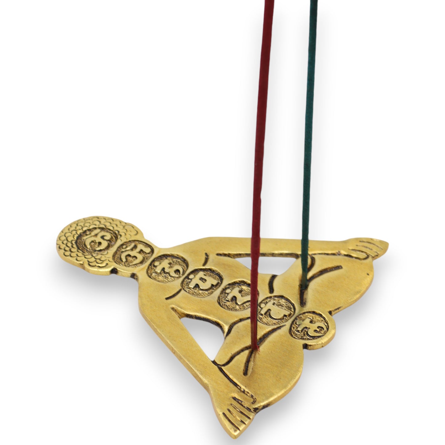 A gold-colored incense holder shaped like a meditating figure holds two incense sticks upright. The figure features chakra symbols along the body, suggesting a focus on mindfulness and meditation.
