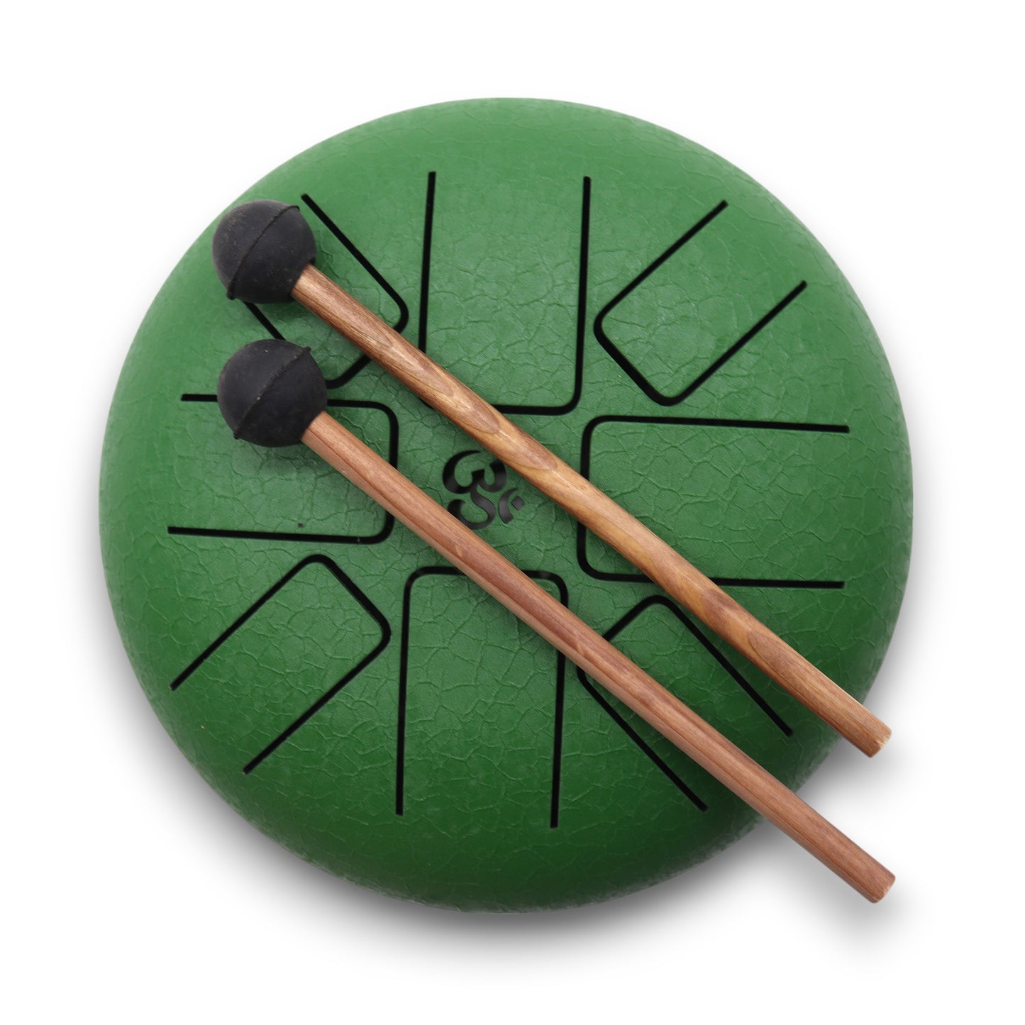 A green steel tongue drum sits on a white background, featuring black cut-out shapes, with two wooden mallets resting on top. The drum has a symbol in the center.