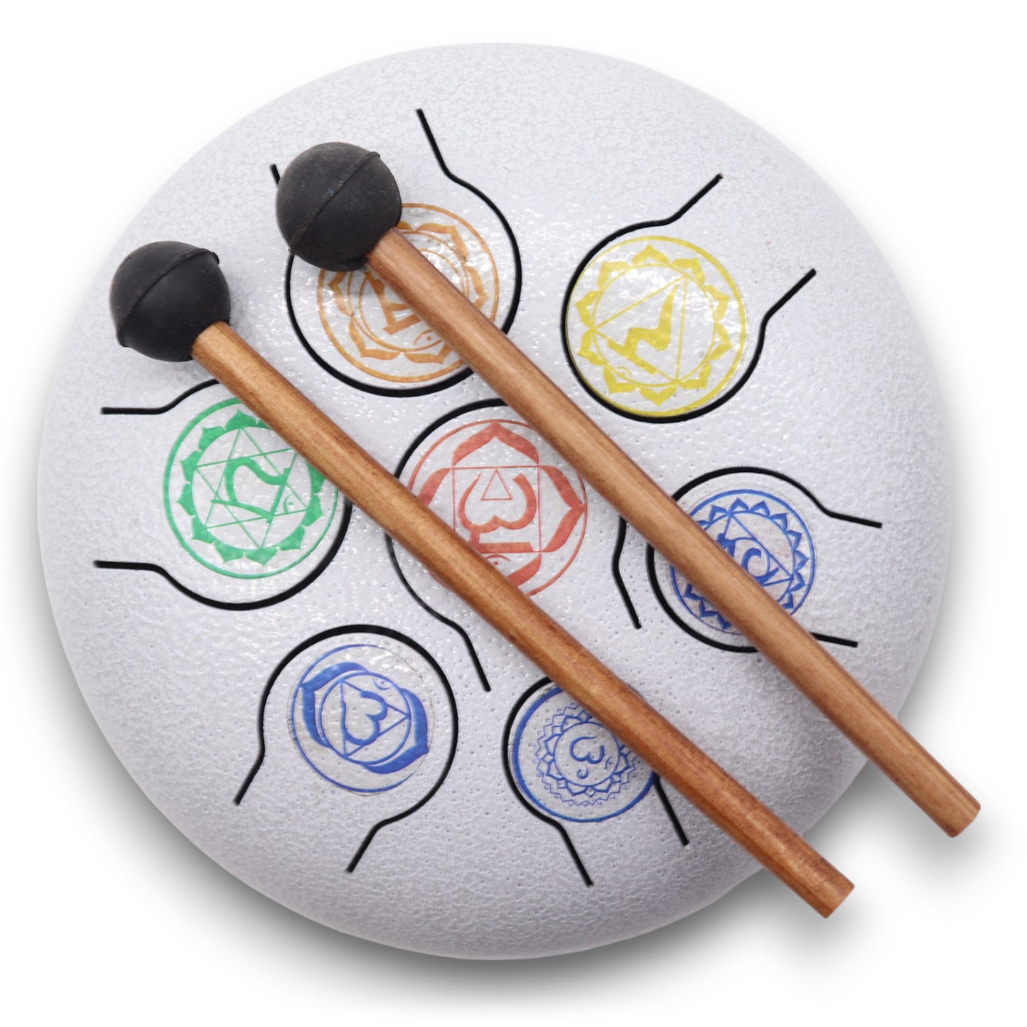 A white steel tongue drum with colorful chakra symbols, decorated with black lines, has two wooden mallets resting across it. The background is plain.