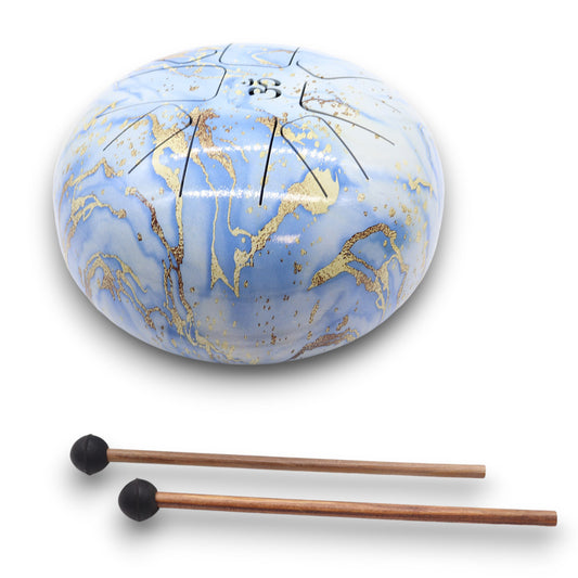 A round blue and gold marbled steel tongue drum rests on a white background, accompanied by two wooden mallets with black rubber tips.