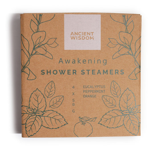 A brown box labeled "Ancient Wisdom, Awakening Shower Steamers" features green botanical illustrations. It contains eucalyptus, peppermint, and orange scents, with quantities listed as 4 x 50g.