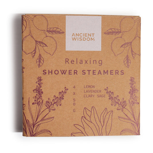 A brown box labeled "Ancient Wisdom" displays "Relaxing Shower Steamers." The illustrated packaging features herbs and citrus, indicating contents of lemon, lavender, and clary sage, weighing 4 x 50 grams.