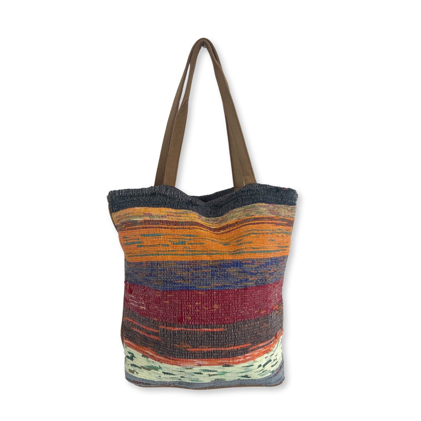 A colorful woven tote bag displays horizontal stripes in orange, red, blue, and green, with brown handles, set against a plain white background.