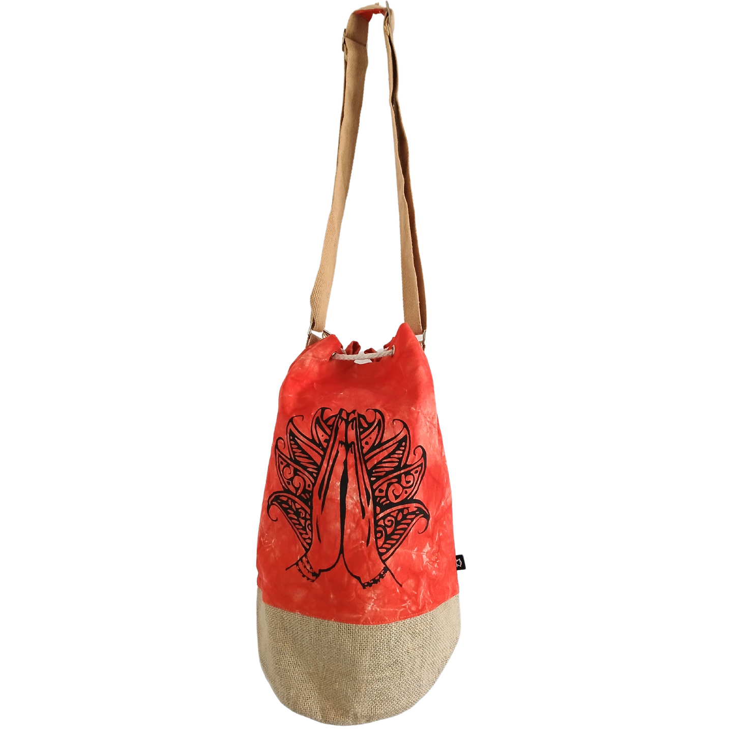 A red and tan drawstring bag with a long strap, featuring a black line drawing of hands in a prayer position, adorned with intricate patterns, set against a solid white background.