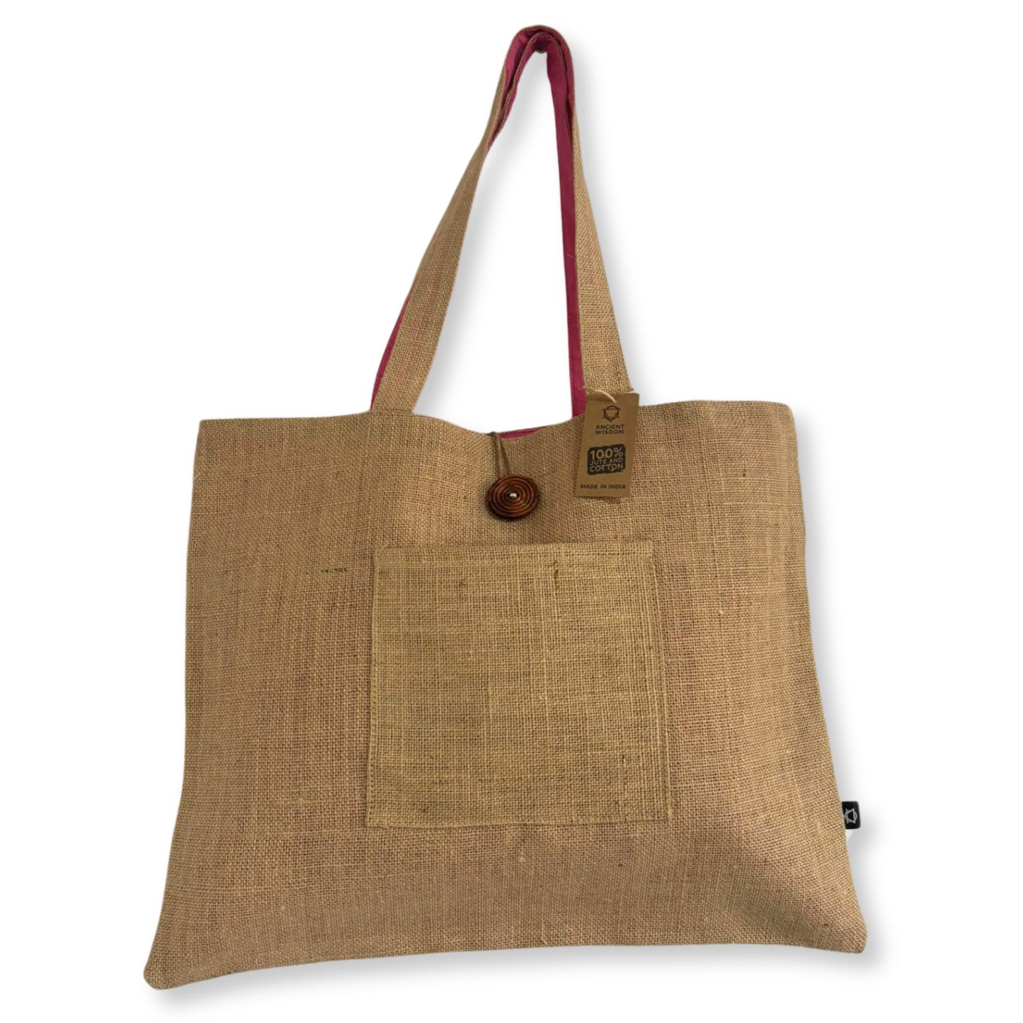 A jute tote bag with red interior handles, featuring a front pocket and a button closure. Attached is a tag reading "100% Jute" and "Made in India."