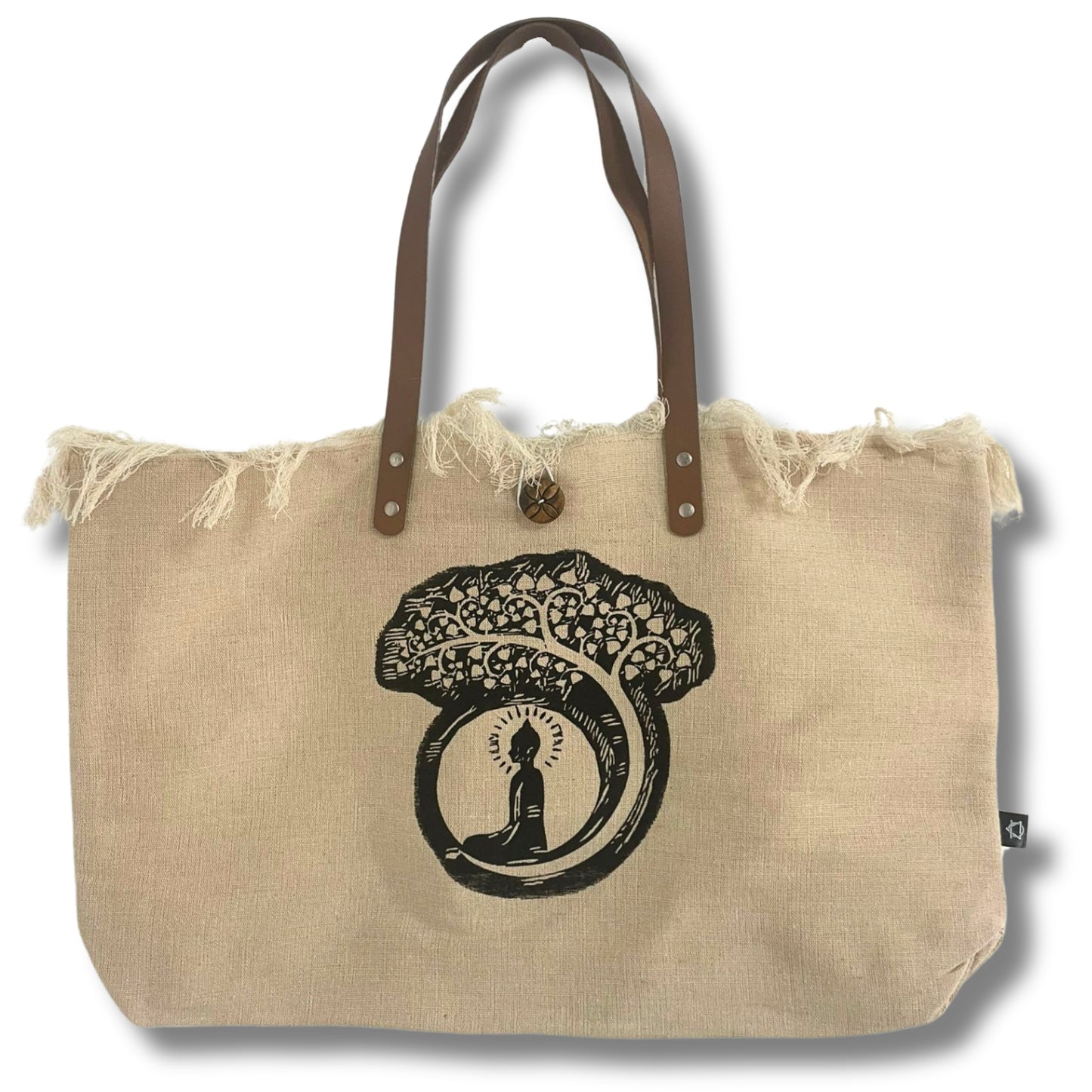 A beige fabric tote bag features an image of a figure meditating under an intricate tree. The bag has brown leather handles and frayed edges, set against a plain background.