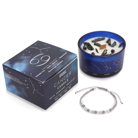 Candle with decorative stones sits beside a box labeled "Ancient Wisdom Cancer Candle with Gemstone Bracelet, Jun. 22 - Jul. 22." A beaded bracelet is also displayed.