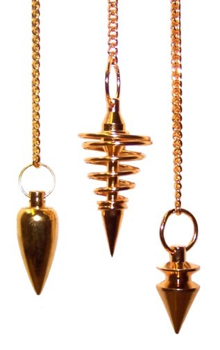 Three golden pendulums hang on delicate chains against a solid white backdrop. The pendulums each have distinct shapes, featuring a cone and spiral design.