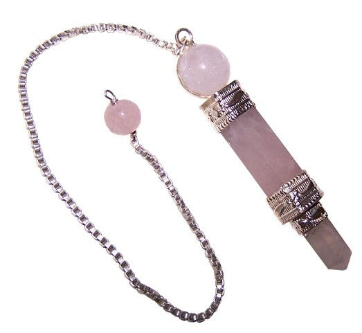A rose quartz pendulum hangs, suspended from a silver chain with a bead near the top, against a white backdrop.