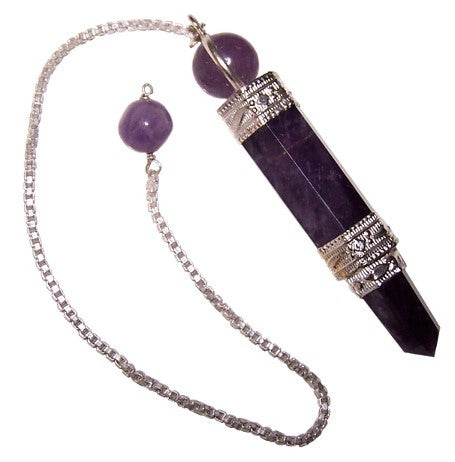 An amethyst pendulum hangs. Its silver chain features a purple bead. The faceted crystal is capped with decorative silver bands and has a rounded stone. The background is white.