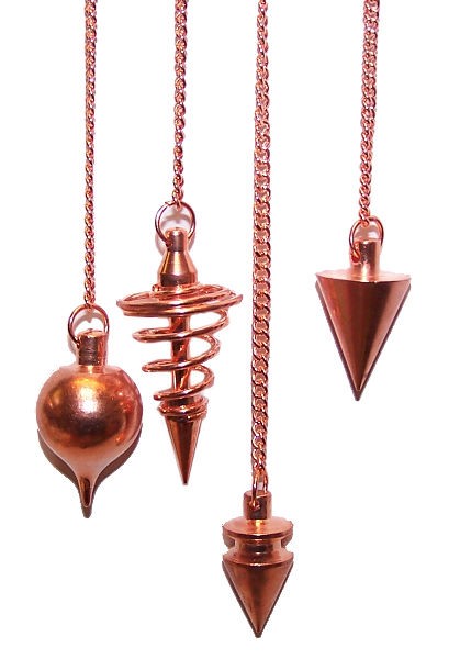 Four copper pendulums, each with a different shaped weight, hang vertically from copper chains against a white background. The weights include a spiral, a cone, and a bulb shape.