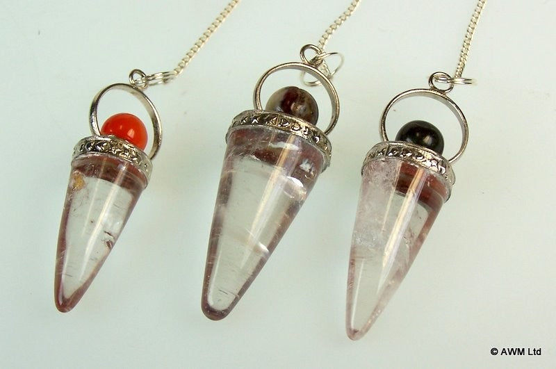 Three crystal pendants hang; each is cone-shaped with a silver cap, a different colored bead, and a silver chain on a white surface.
© AWM Ltd