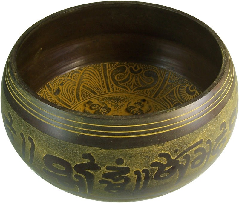 A brown bowl with intricate carvings sits empty. The interior features ornate, floral patterns. The exterior displays decorative script, encircled by golden lines, set in a plain background.