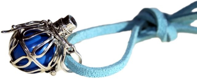 A blue ball inside a silver cage sits attached to a light-blue cord. The cord is tied in a knot and has tassels on the end.